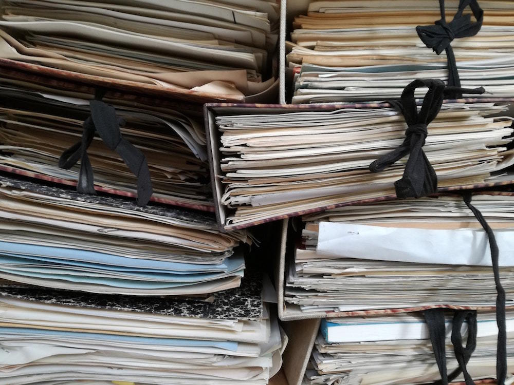 stack of papers tied with black ribbon