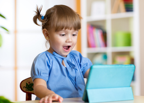 child playing with a digital tablet at home