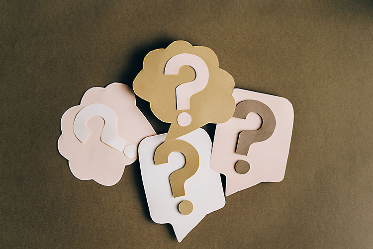 question marks on a brown background