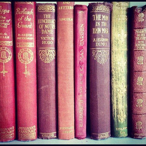 stack of eight red books with gold titles