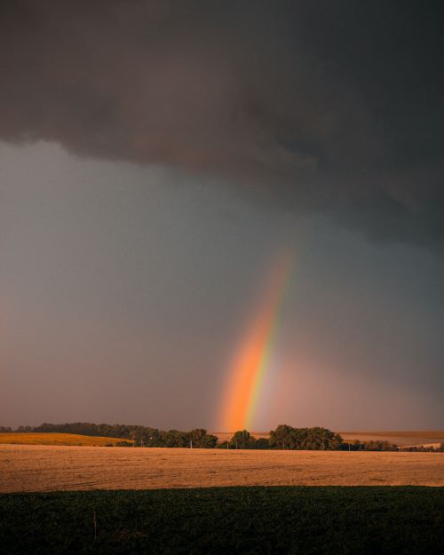 rainbow coming out of dark clouds