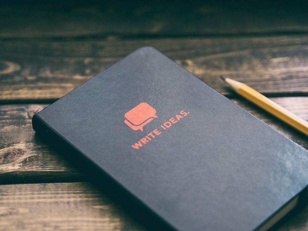 notebook with "write ideas" on the cover