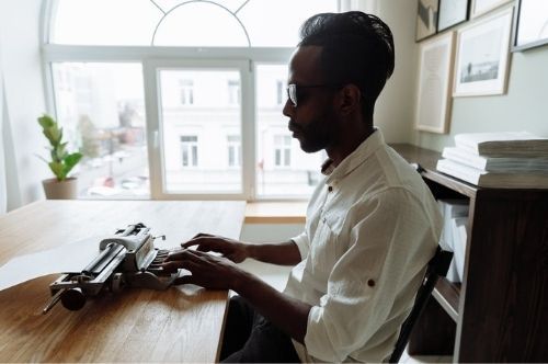 A blind man using a braille typewriter.