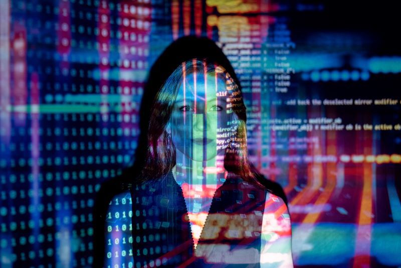 A woman surrounded by data figures and lights