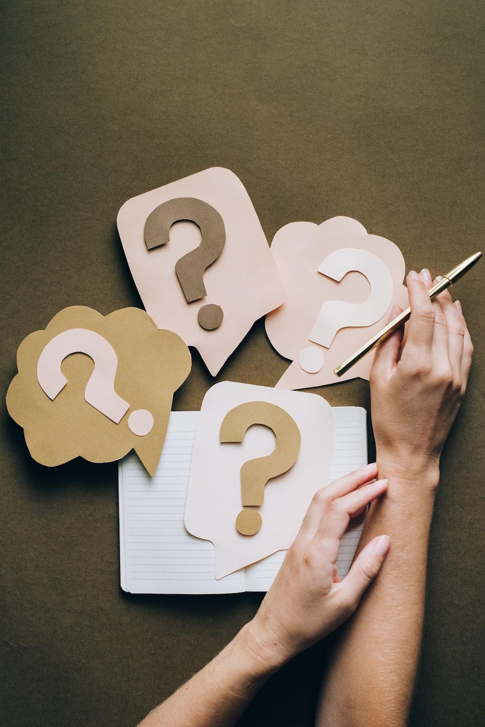 paper question marks in paper speech bubbles