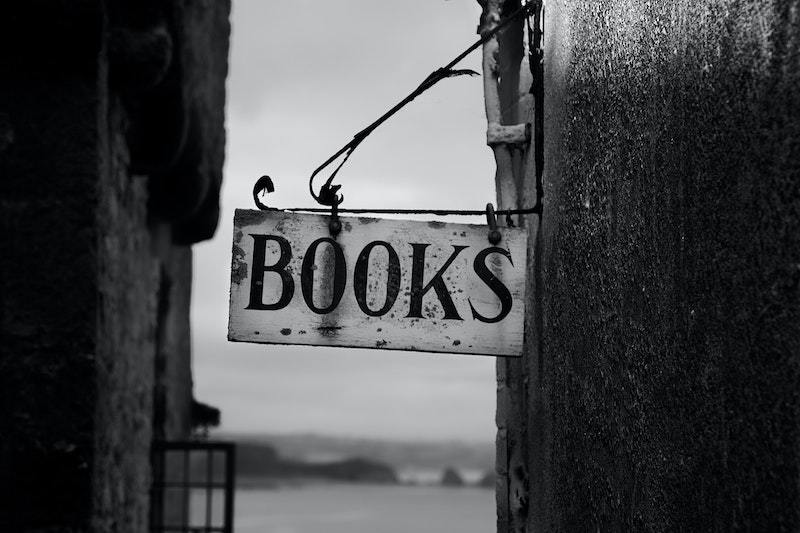 black and white photo of vintage "Books" sign on building
