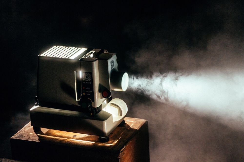 old fashioned movie projector surrounded by mist