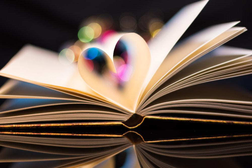 A book with two pages curved up to form the shape of a heart