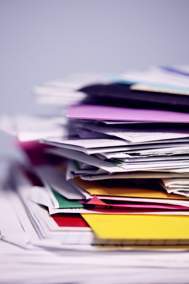 disorderly stacked papers and folders