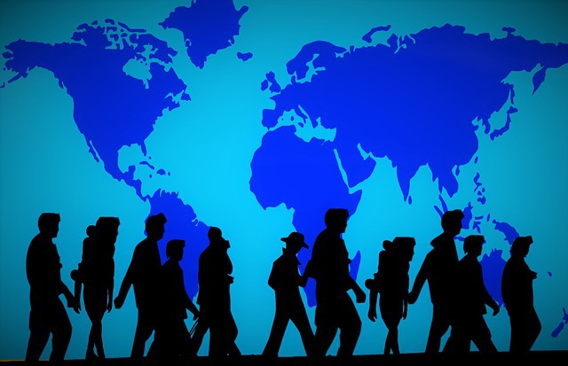 Simplified map of the world in shades of blue with the silhouettes of people walking from left to right