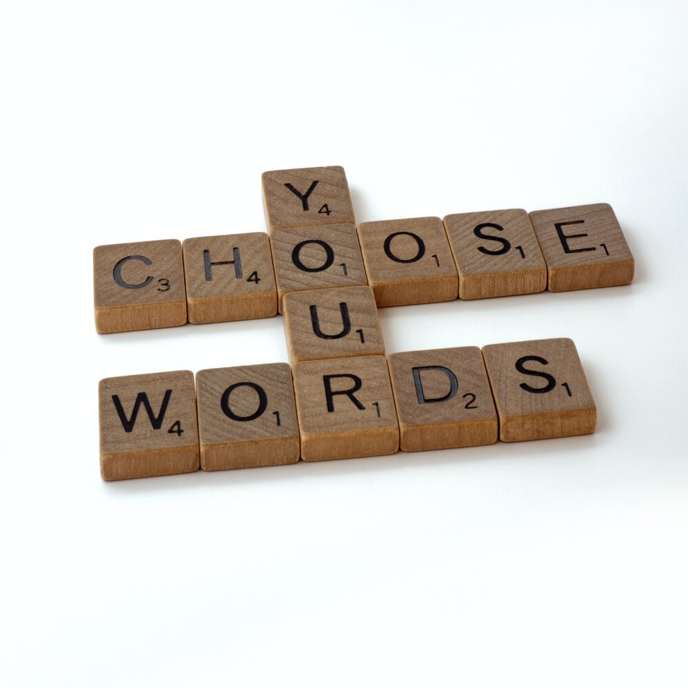 Scrabble blocks arranged to read "Choose your words."