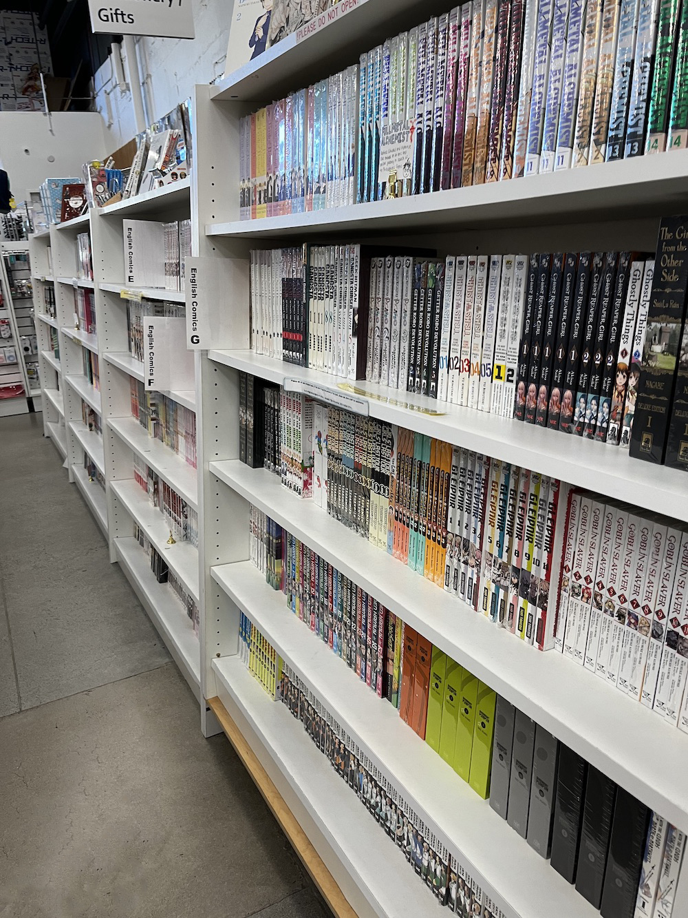 A bookshelf at Kinokuniya that shows how manga is often sorted alphabetically by book title.