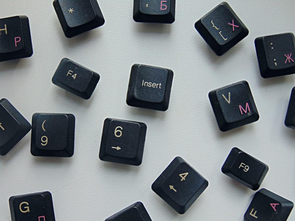Black keyboard keys scattered against a white background.