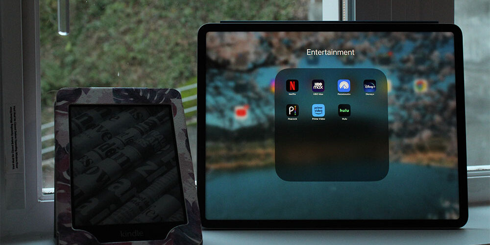iPad on Entertainment screen with streaming apps on it. A Kindle with newspapers on the screen is next to the iPad.